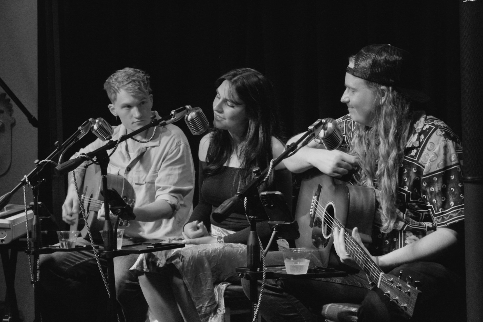 Three Nashville songwriters in the round, in black and white