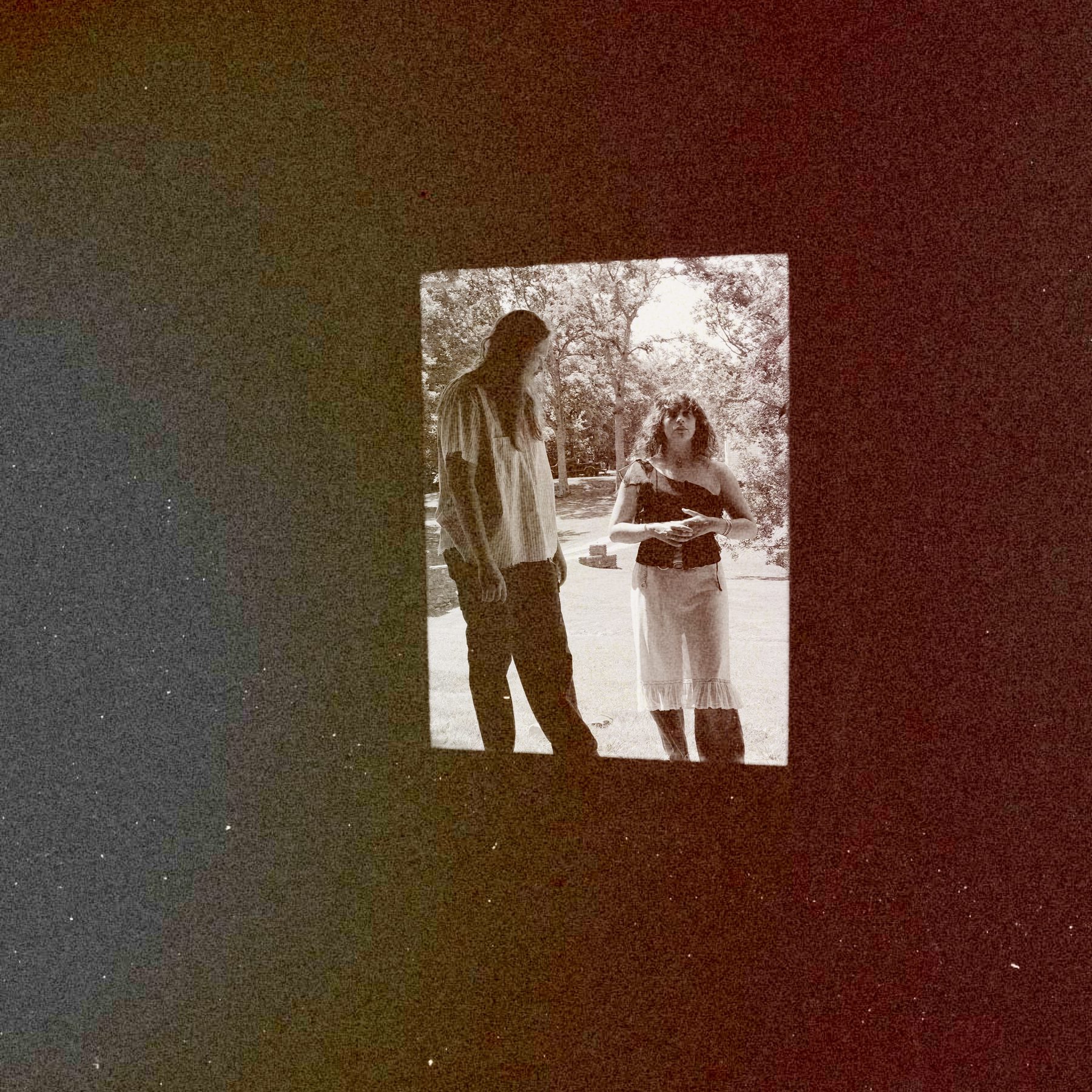 Ben Becker and Eva Arnby framed in a window