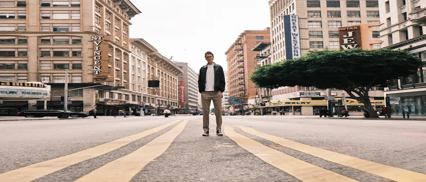 Owen Waidley standing in the middle of a downtown street