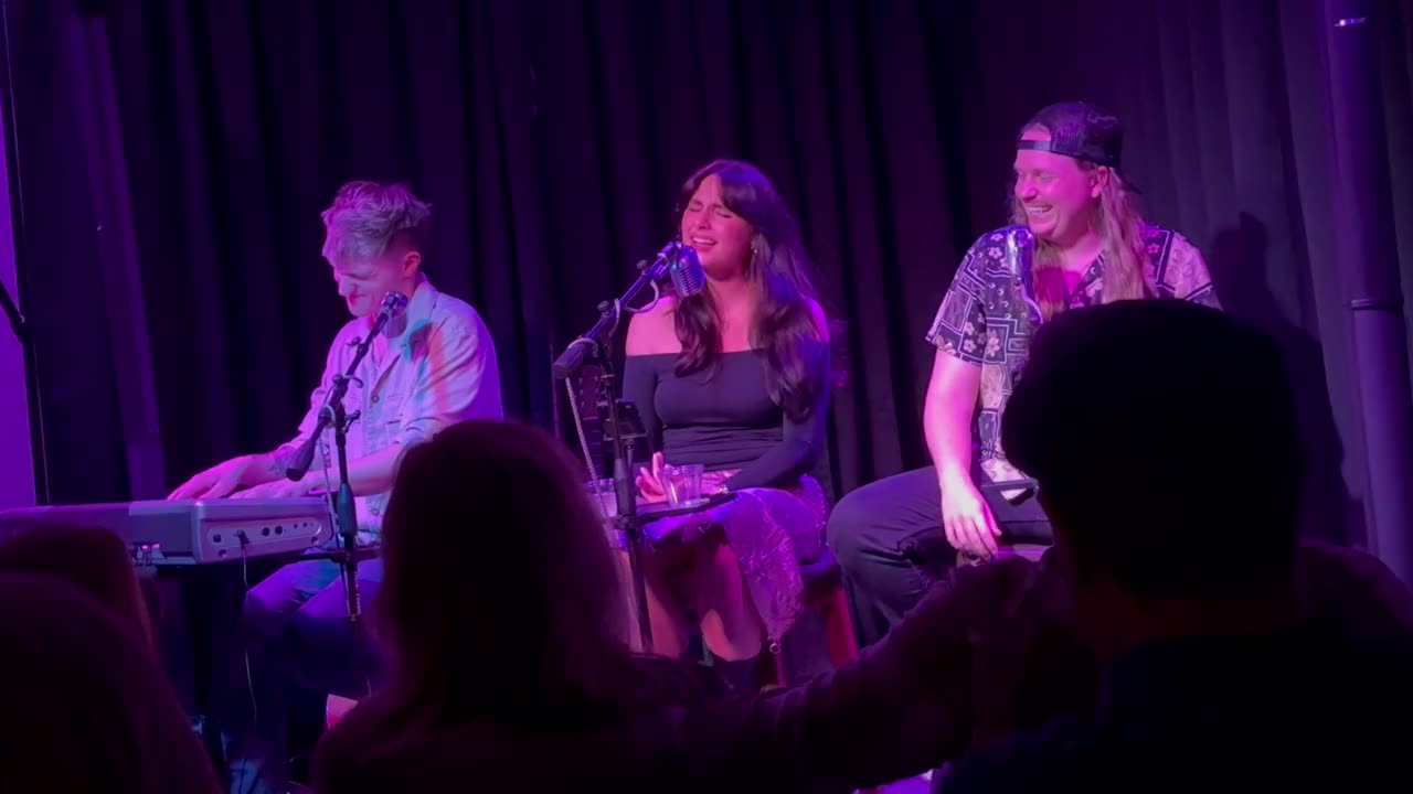 Cam Becker, Ari Elle and Ben Becker on the corner stage