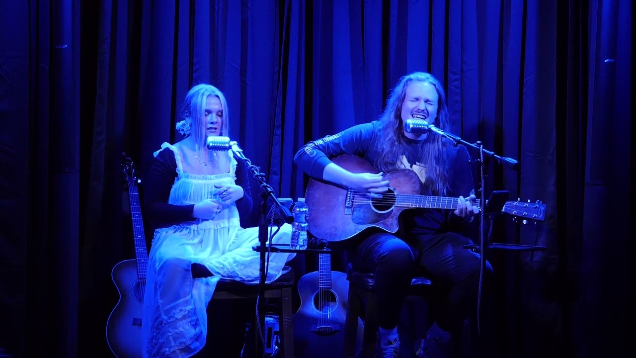 Kyndal Inskeep and Ben Becker on the stage under blue light
